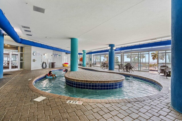 504 N Ocean Blvd N Unit 309, Myrtle Beach, SC 29577 - indoor pool with french doors and a patio area
