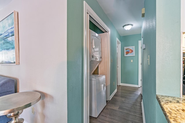 2805 N Ocean Blvd Unit 113, Myrtle Beach, SC 29577 - washroom featuring stacked washer / dryer, dark wood-type flooring, and baseboards