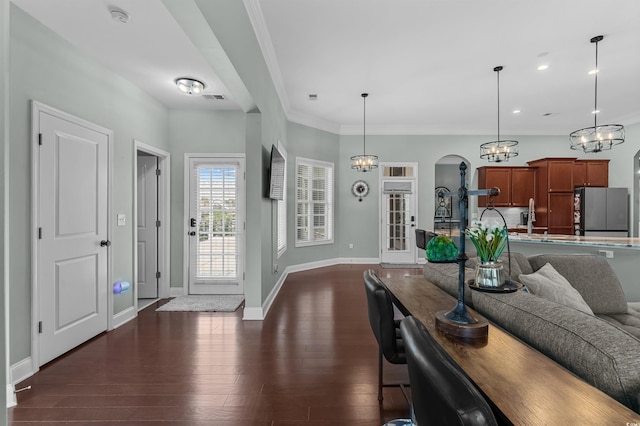 foyer featuring a chandelier, baseboards, crown molding, dark wood-type flooring, and recessed lighting