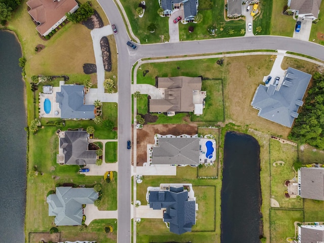aerial view of property's location with nearby suburban area and a nearby body of water