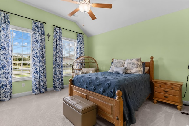 carpeted bedroom with vaulted ceiling, baseboards, and a ceiling fan