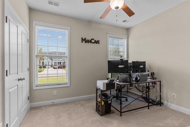 carpeted office with baseboards and ceiling fan