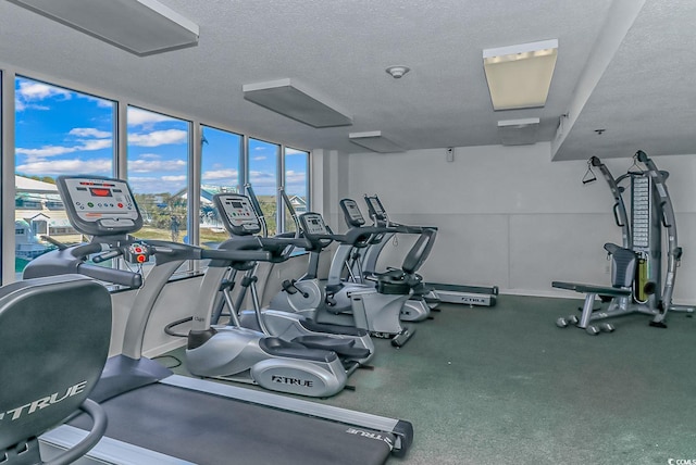 exercise room with a textured ceiling