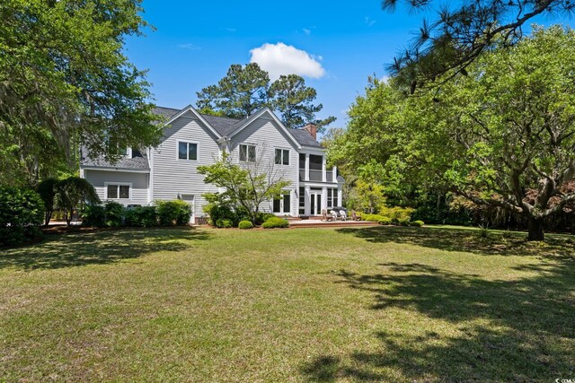 352 Old Carriage Loop, Georgetown, SC 29440 - rear view of property featuring a yard, a chimney, a deck, and french doors