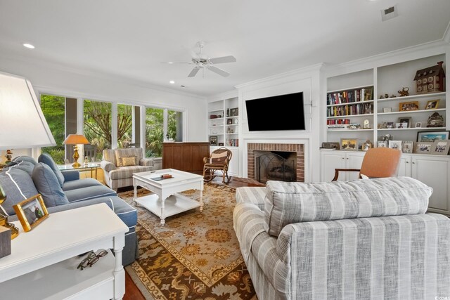352 Old Carriage Loop, Georgetown, SC 29440 - living room with ornamental molding, ceiling fan, a fireplace, wood finished floors, and built in shelves
