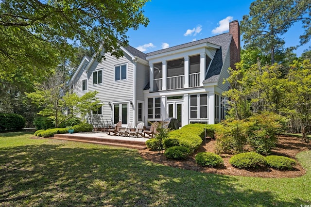 352 Old Carriage Loop, Georgetown, SC 29440 - back of house featuring a yard, a chimney, a shingled roof, french doors, and a sunroom