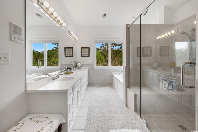 352 Old Carriage Loop, Georgetown, SC 29440 - full bathroom with tile patterned floors, a stall shower, a bath, double vanity, and tile walls