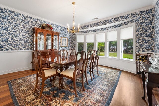 352 Old Carriage Loop, Georgetown, SC 29440 - dining area featuring wainscoting, a chandelier, wallpapered walls, ornamental molding, and wood finished floors