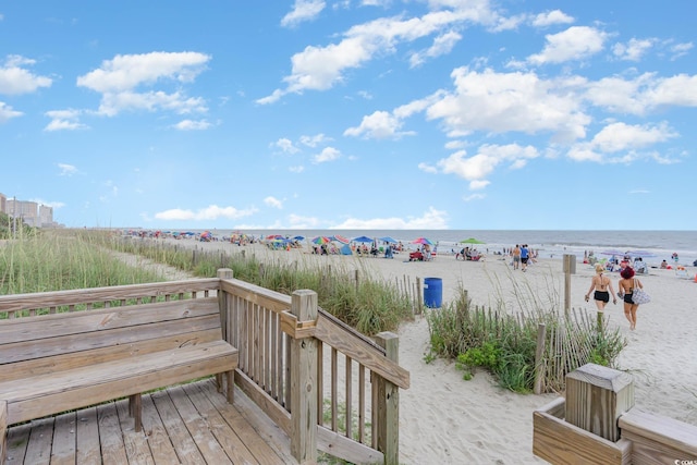 deck with view of water and beach