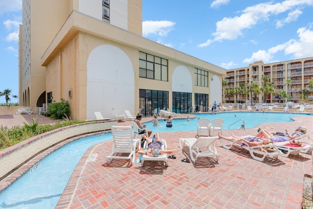 community pool with a patio area