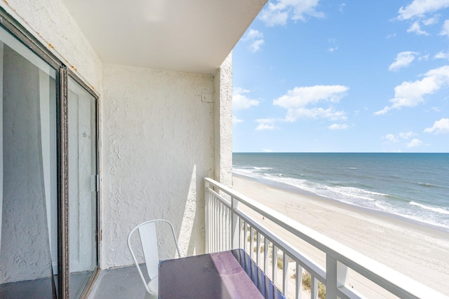 balcony featuring view of water and beach