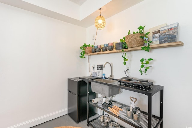 office featuring baseboards and a sink