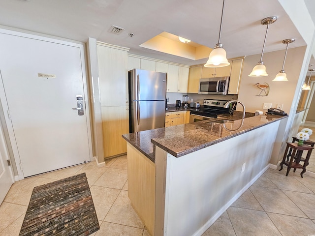 9820 Queensway Blvd Unit 1603, Myrtle Beach, SC 29572 - kitchen featuring appliances with stainless steel finishes, a peninsula, light tile patterned floors, dark stone counters, and a sink