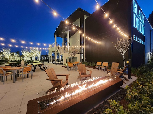 9820 Queensway Blvd Unit 1603, Myrtle Beach, SC 29572 - patio at night with a fire pit and outdoor dining space