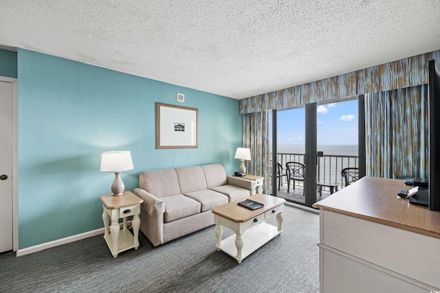 2701 N Ocean Blvd Unit 1260, Myrtle Beach, SC 29577 - carpeted living room with a water view, a textured ceiling, and baseboards