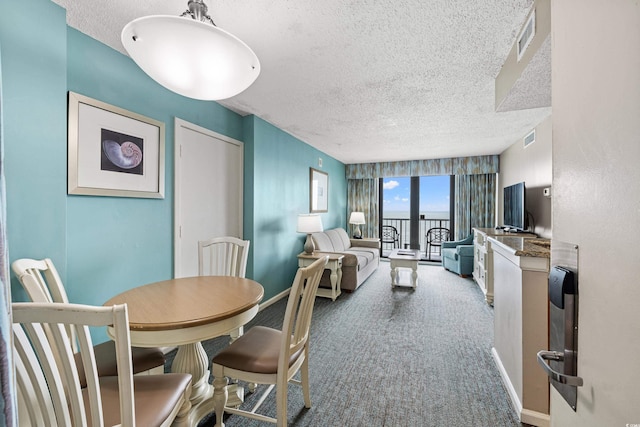 2701 N Ocean Blvd Unit 1260, Myrtle Beach, SC 29577 - dining space with a textured ceiling, carpet floors, and baseboards