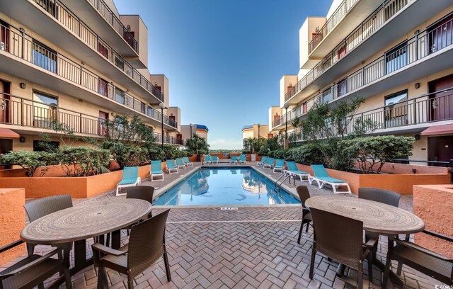 community pool featuring a patio area