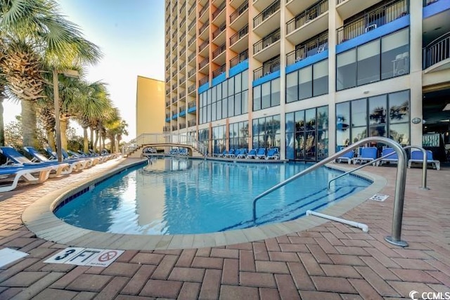 community pool featuring a patio area