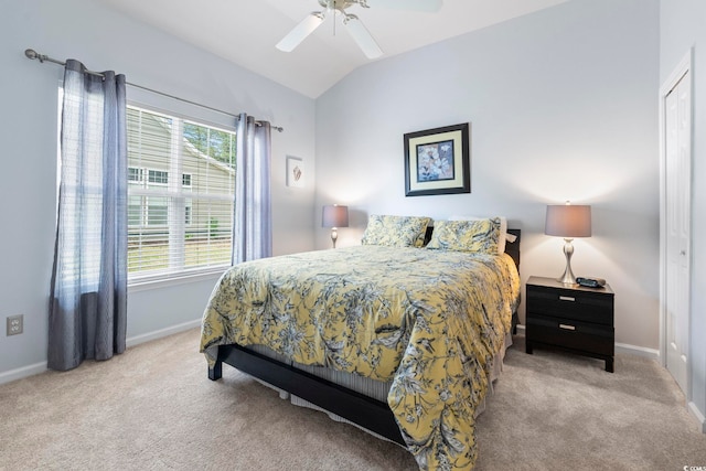carpeted bedroom featuring lofted ceiling, baseboards, and ceiling fan
