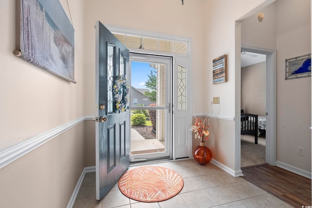 foyer entrance featuring baseboards and light tile patterned flooring