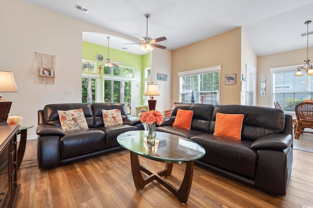 living room featuring ceiling fan, wood finished floors, and lofted ceiling