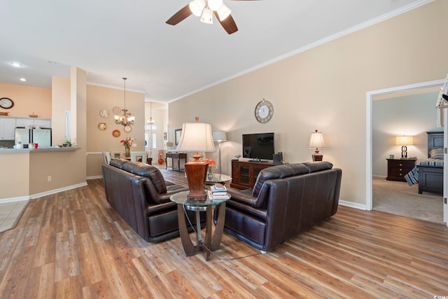 living area featuring a chandelier, ceiling fan, light wood-type flooring, ornamental molding, and baseboards