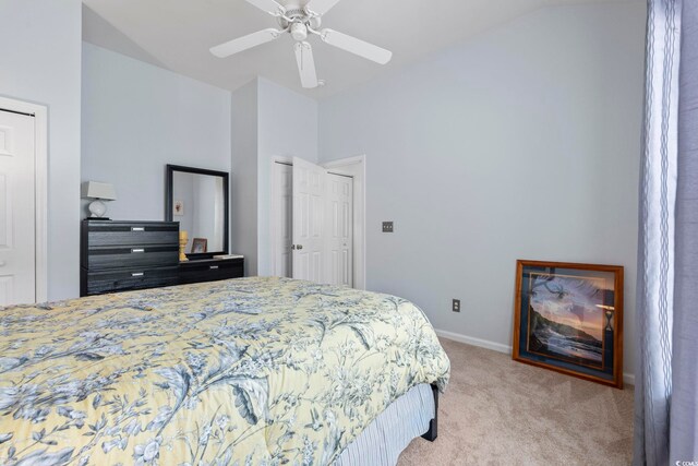 bedroom with light colored carpet, vaulted ceiling, baseboards, and a ceiling fan