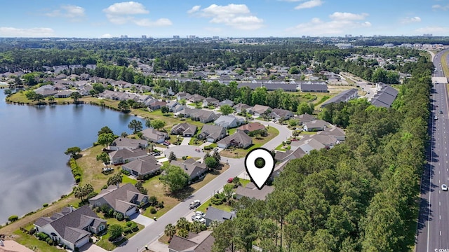aerial view of property's location with nearby suburban area and a large body of water