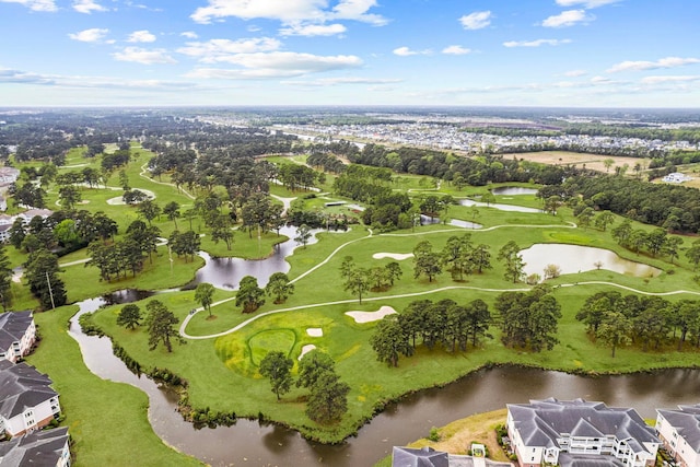 aerial view of property and surrounding area with a large body of water, a local golf course, nearby suburban area, and a tree filled landscape