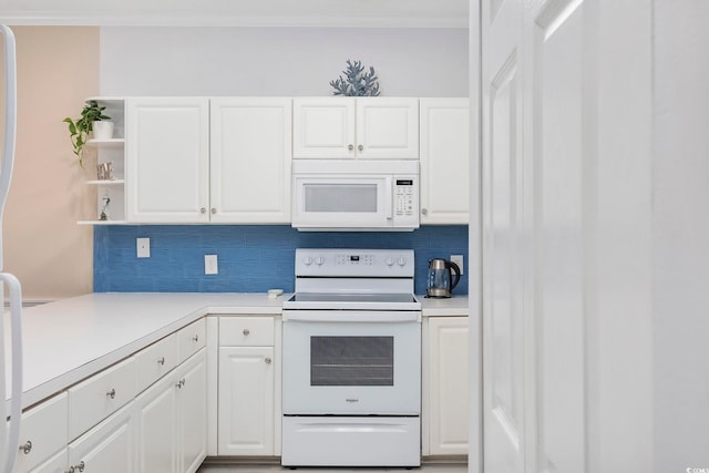 kitchen featuring white appliances, tasteful backsplash, ornamental molding, light countertops, and white cabinetry