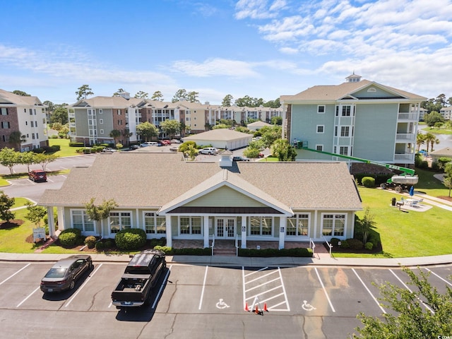 view of property featuring uncovered parking and a residential view