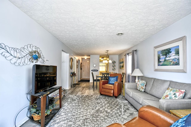 9621 Shore Dr Unit F-117, Myrtle Beach, SC 29572 - living area featuring wood finished floors, a chandelier, and a textured ceiling