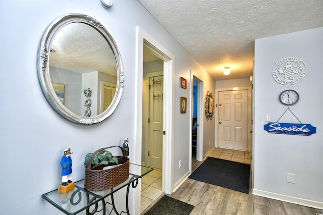 9621 Shore Dr Unit F-117, Myrtle Beach, SC 29572 - corridor with a textured ceiling, baseboards, and wood finished floors