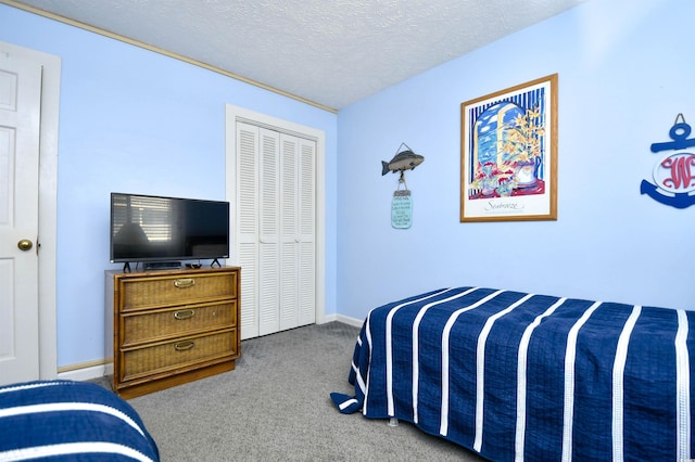 9621 Shore Dr Unit F-117, Myrtle Beach, SC 29572 - bedroom with carpet, a textured ceiling, a closet, and baseboards