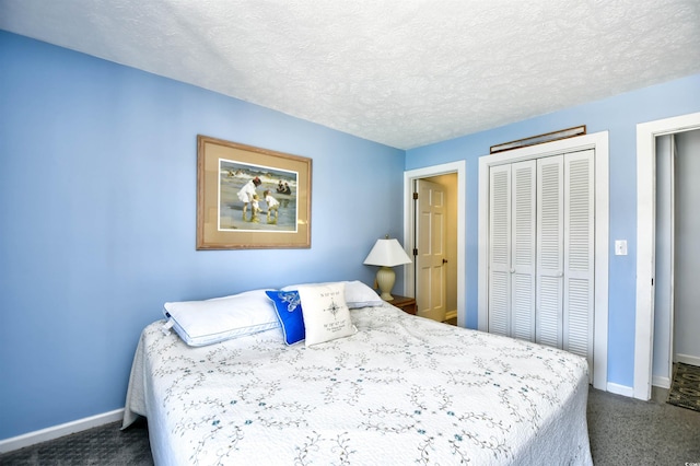 9621 Shore Dr Unit F-117, Myrtle Beach, SC 29572 - bedroom with baseboards, a closet, dark carpet, and a textured ceiling