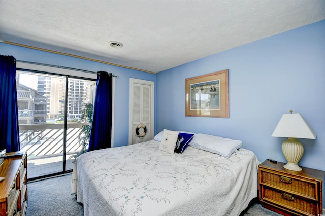 9621 Shore Dr Unit F-117, Myrtle Beach, SC 29572 - carpeted bedroom with access to outside, a closet, and a textured ceiling