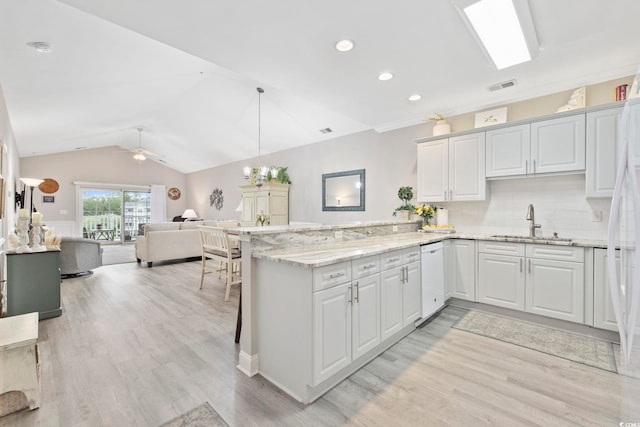 4828 Magnolia Lakes Dr Unit 404, Myrtle Beach, SC 29577 - kitchen featuring a sink, white appliances, lofted ceiling, a peninsula, and light wood finished floors