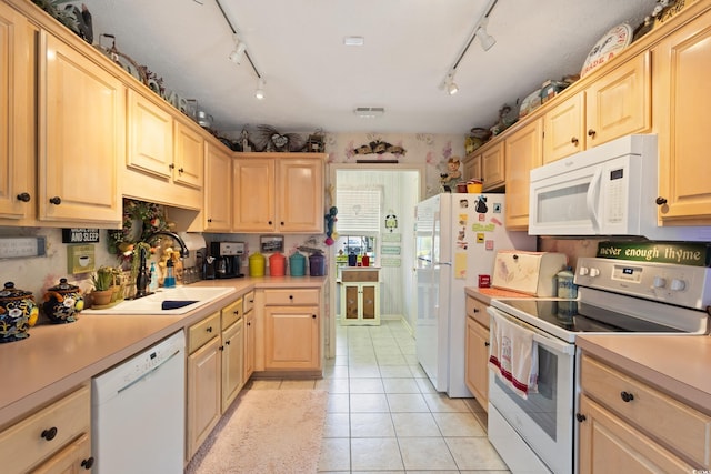 kitchen with white appliances, light brown cabinets, and light countertops