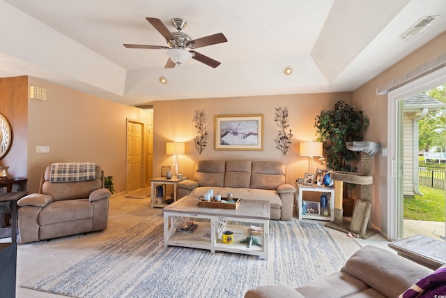 living room with a raised ceiling, a ceiling fan, carpet flooring, and recessed lighting