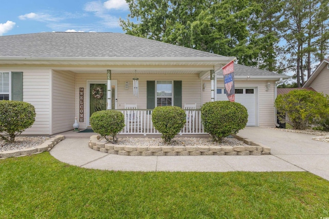 view of front facade with an attached garage, a shingled roof, covered porch, and driveway