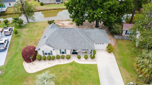 aerial view of property and surrounding area with a nearby body of water