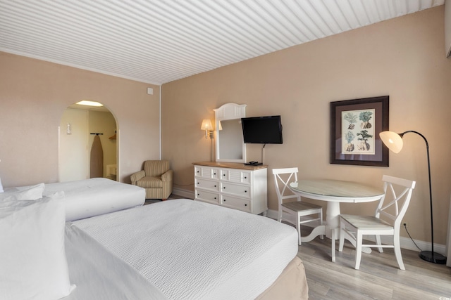 6803 N Ocean Blvd Unit 228, Myrtle Beach, SC 29572 - bedroom featuring light wood-style floors and arched walkways