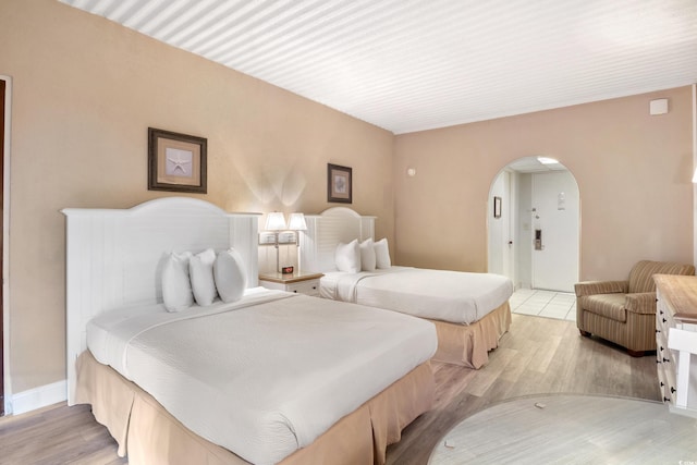6803 N Ocean Blvd Unit 228, Myrtle Beach, SC 29572 - bedroom featuring arched walkways and light wood-style flooring