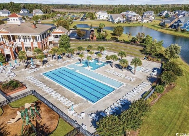 community pool with a water view and a residential view