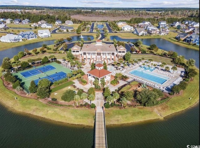 view of property location with a nearby body of water and a pool area