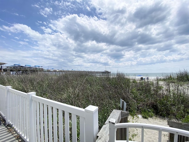 balcony featuring view of water and beach