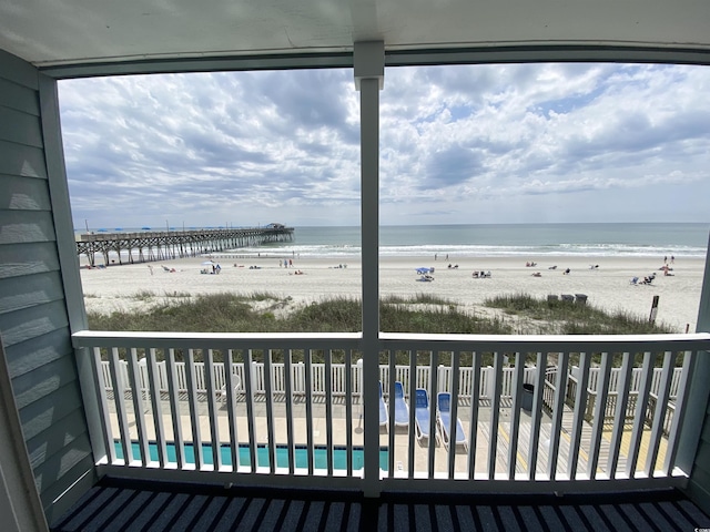 balcony with view of water and beach