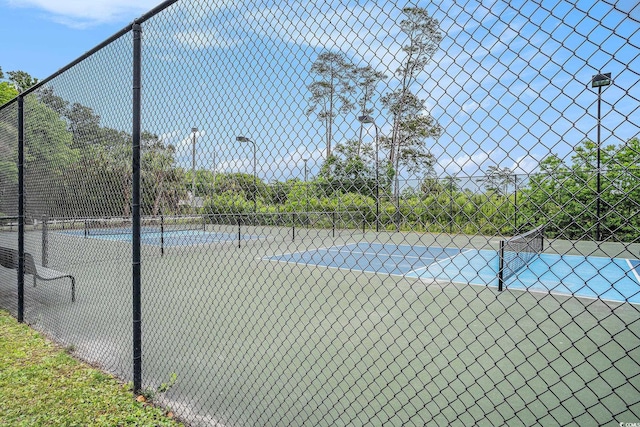 view of tennis court with fence