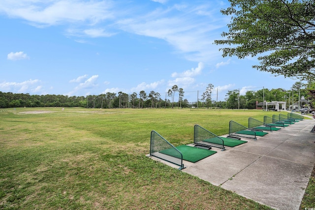 view of home's community featuring a lawn and view of scattered trees