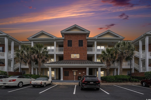 view of building exterior featuring uncovered parking